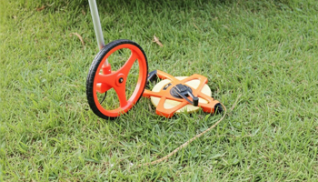 Tape measure in the grass of a homeowners backyard